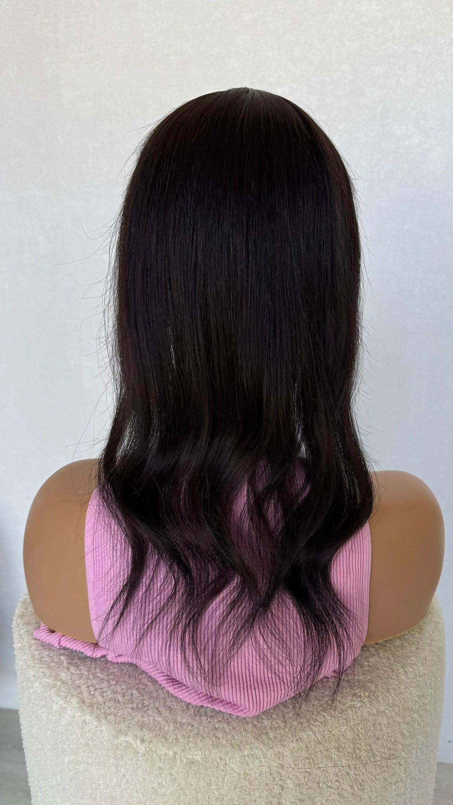 20 inch black hair topper from back view, curled