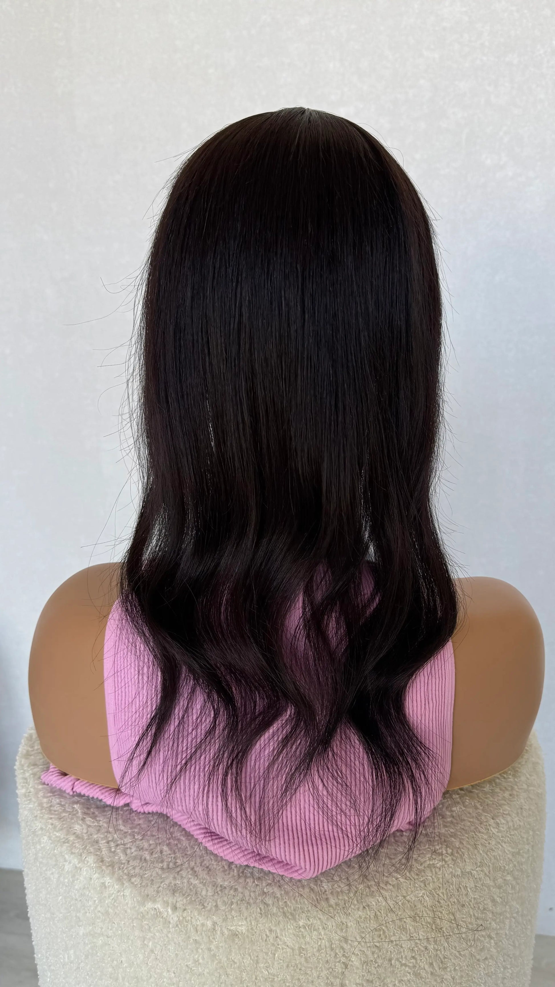 20 inch black hair topper from back view, curled