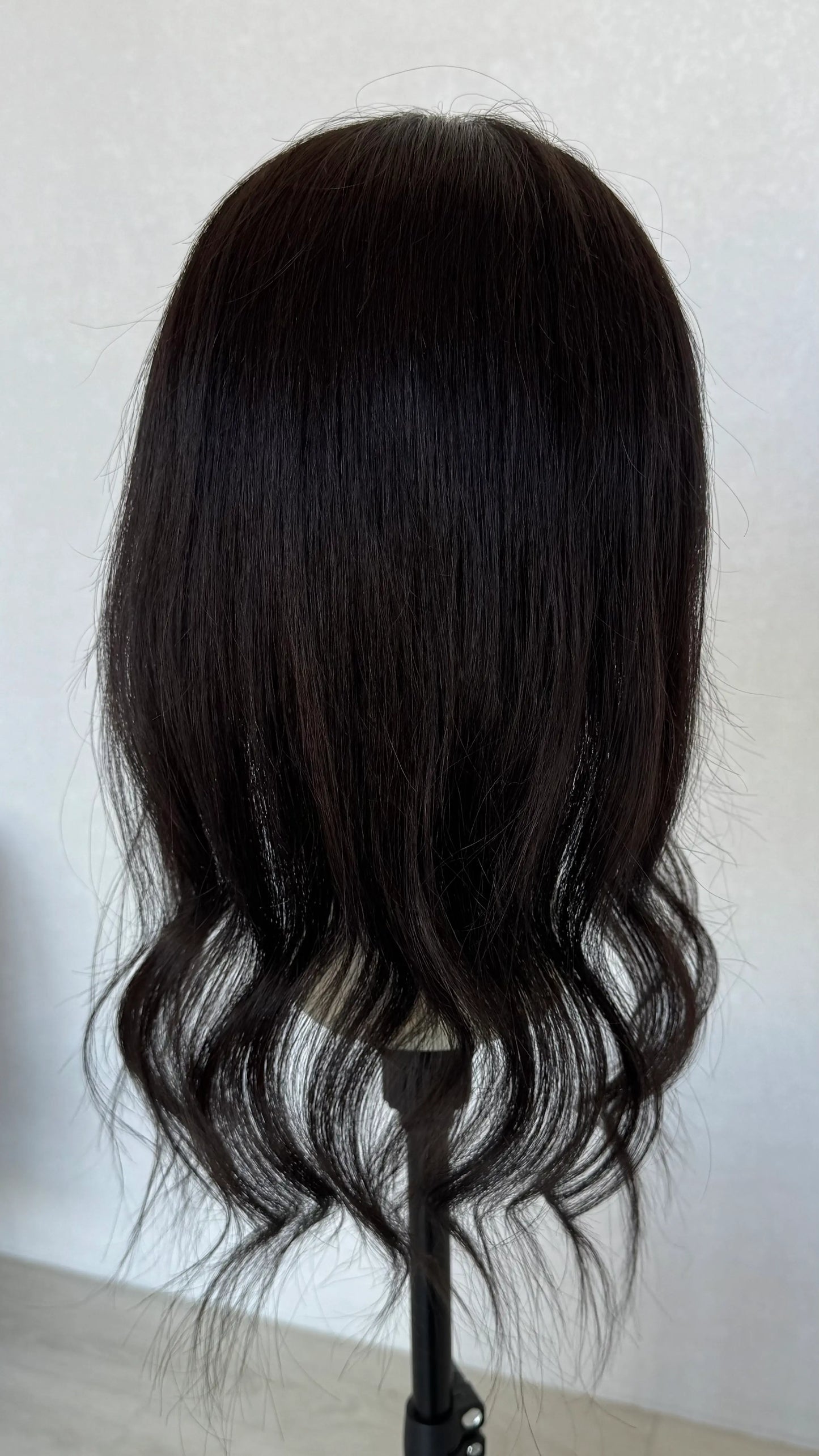 20 inch black human hair topper from behind 