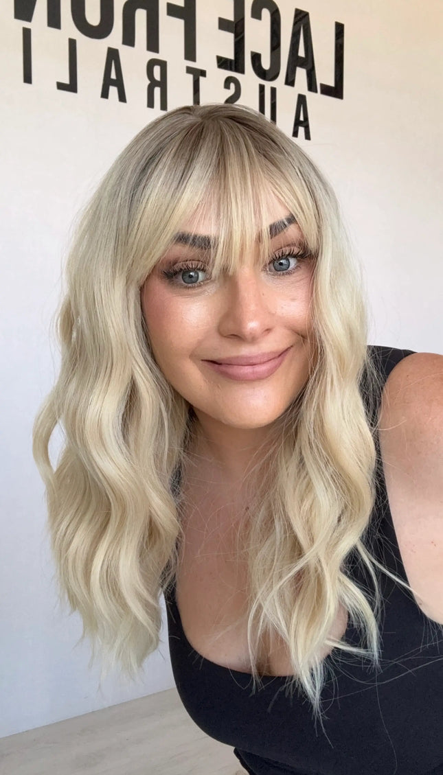 middle part, wavy blonde hair synthetic topper, heat safe and gluless.