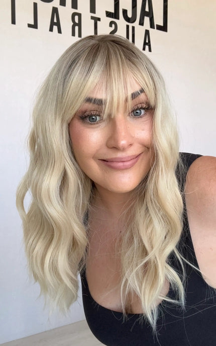 middle part, wavy blonde hair synthetic topper, heat safe and gluless.