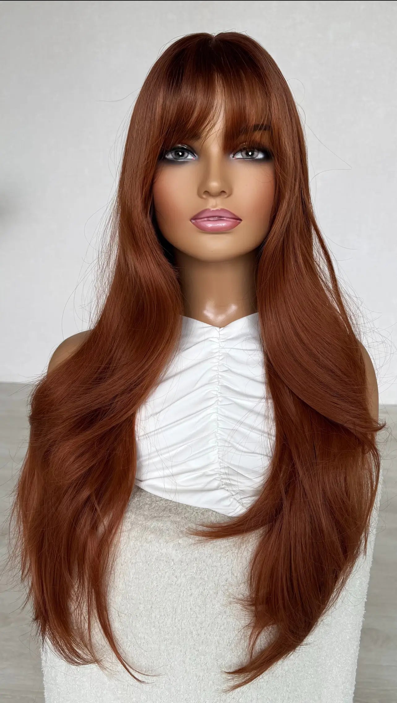 front view of dark copper, deep root with fringe. long hair synthetic wig.