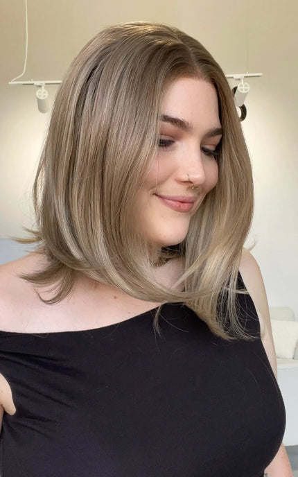 A lace front glueless heat safe blonde synthetic 12 inch bob wig.