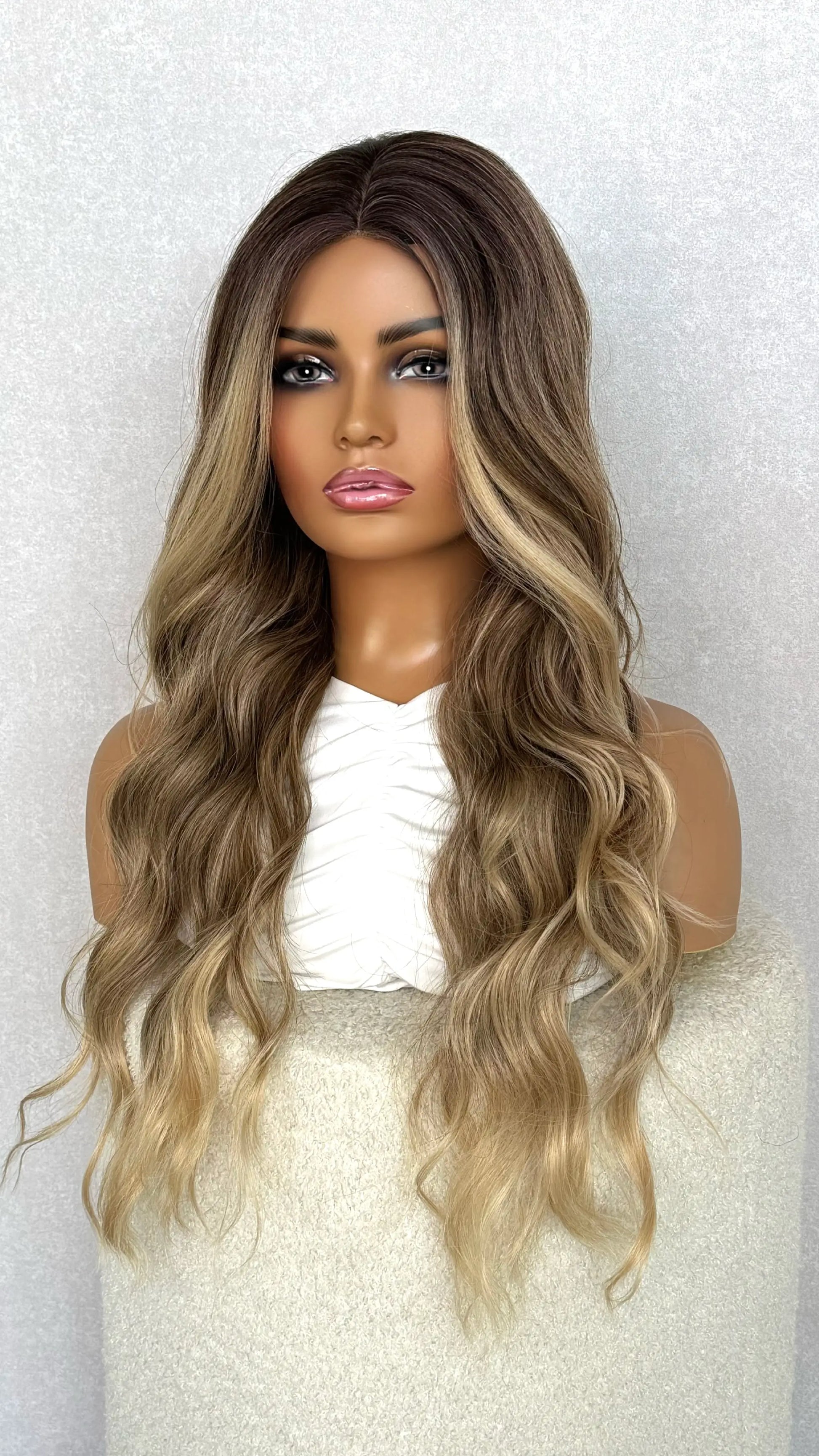 side view of ombre brown synthetic wig. queen, money piece, highlights throughout.