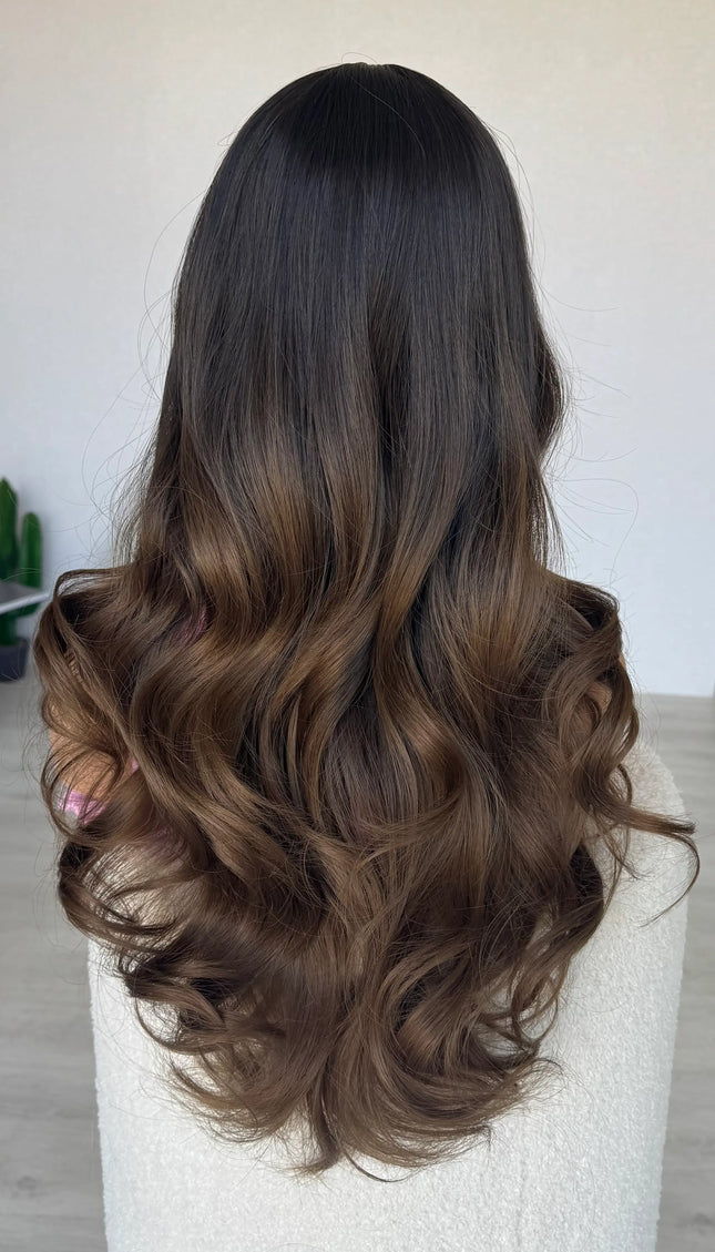 long brown hair middle part, darker root to brown ends.