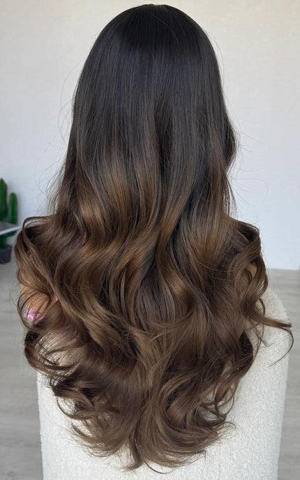 long brown hair middle part, darker root to brown ends.