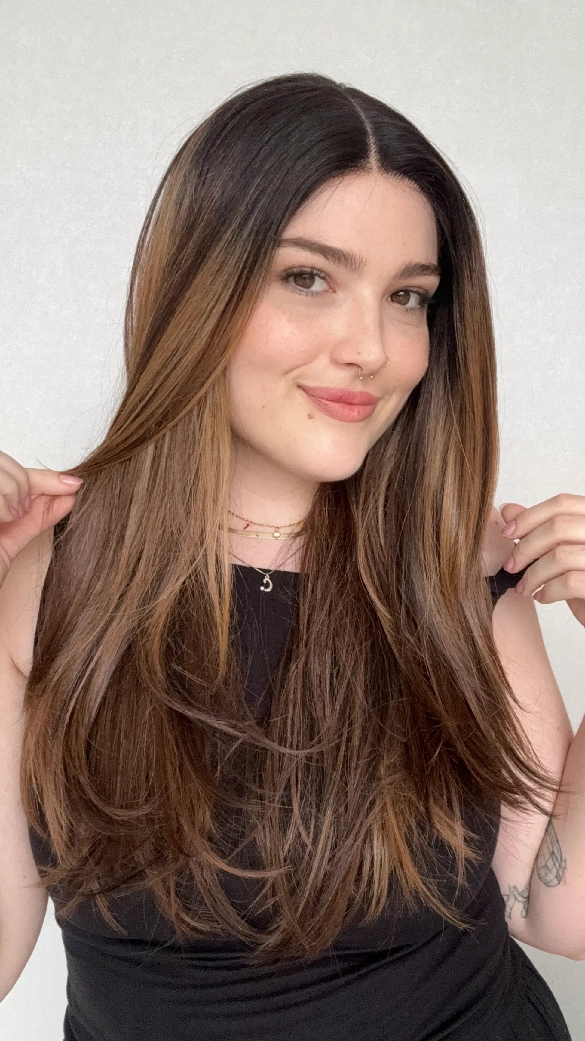 layered hair, brunette ombre, warm tones, middle part.