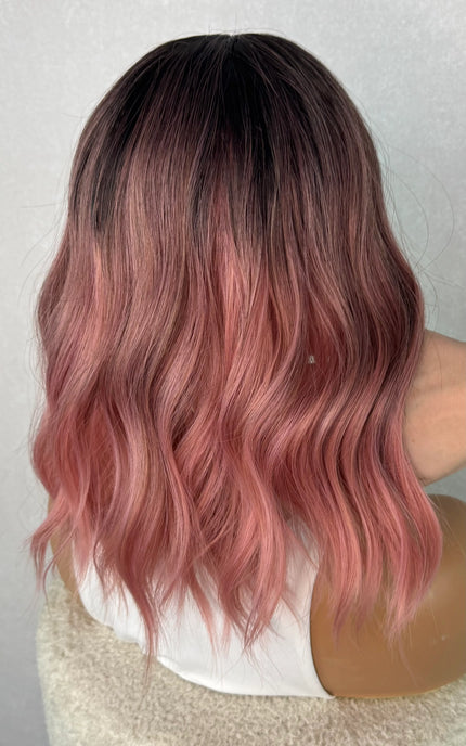 pink wig from the back, showcasing the ombre blend from dark to pink. 