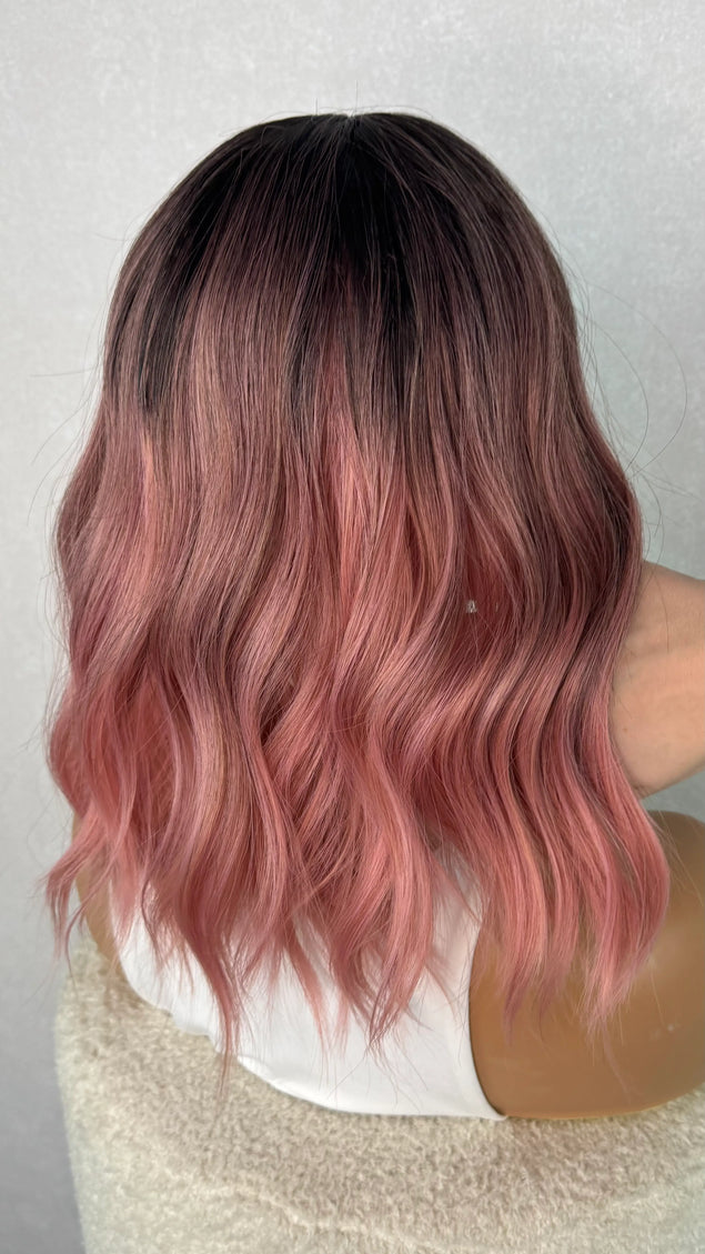 pink wig from the back, showcasing the ombre blend from dark to pink. 