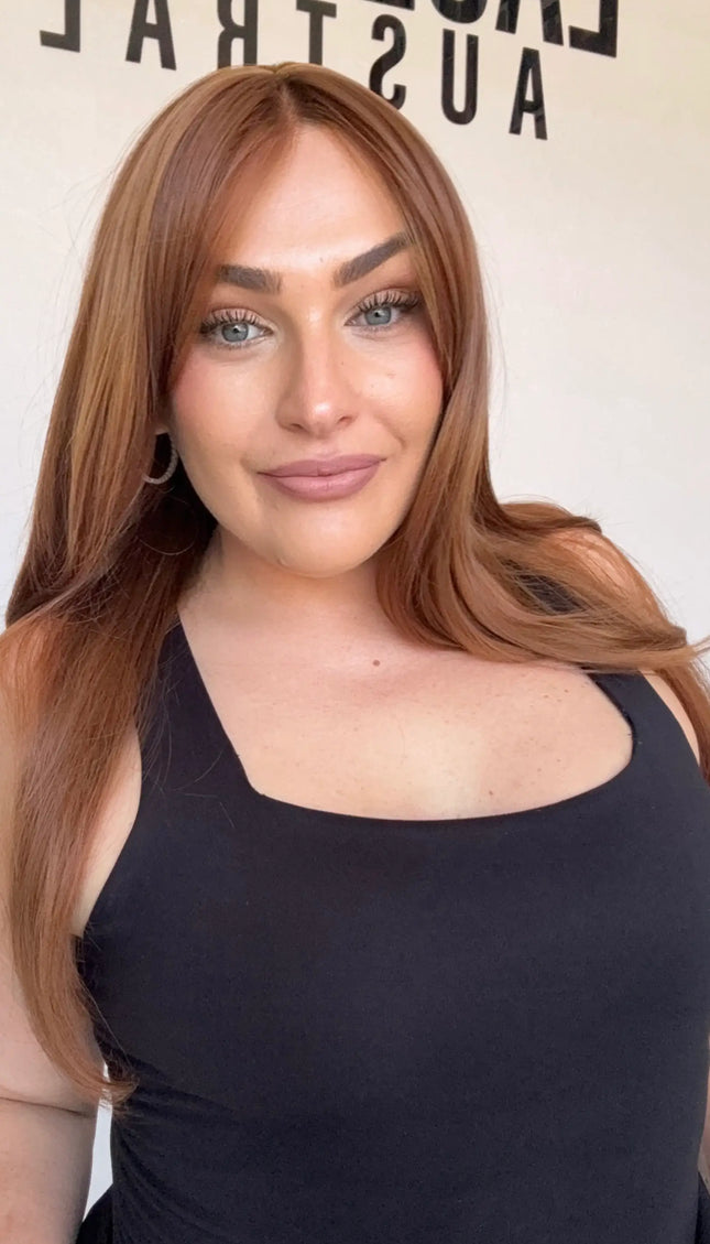 copper heat safe wig with curtain bangs and middle part.