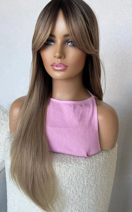 long hair champagne toned hair with dark root, middle part with curtain bangs.