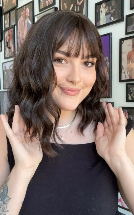heat safe synthetic wig with dark brown wavy hair and fringe.