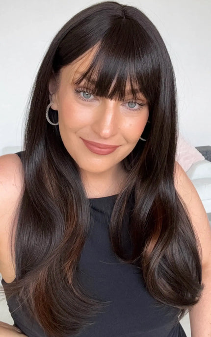 dark brunette with chesnut highlights on the underside, a middle part and soft fringe. 