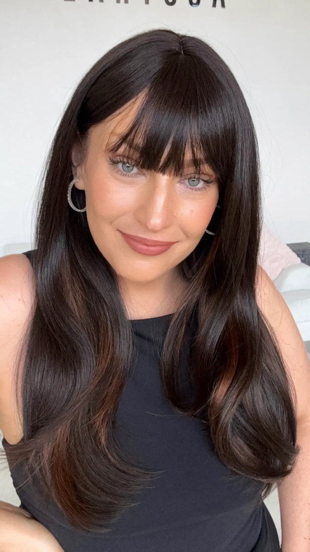 dark brunette with chesnut highlights on the underside, a middle part and soft fringe. 