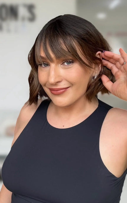 wavy brunette ombre hair with warm brunette ends, long fringe with middle part and glueless easy to wear cap.