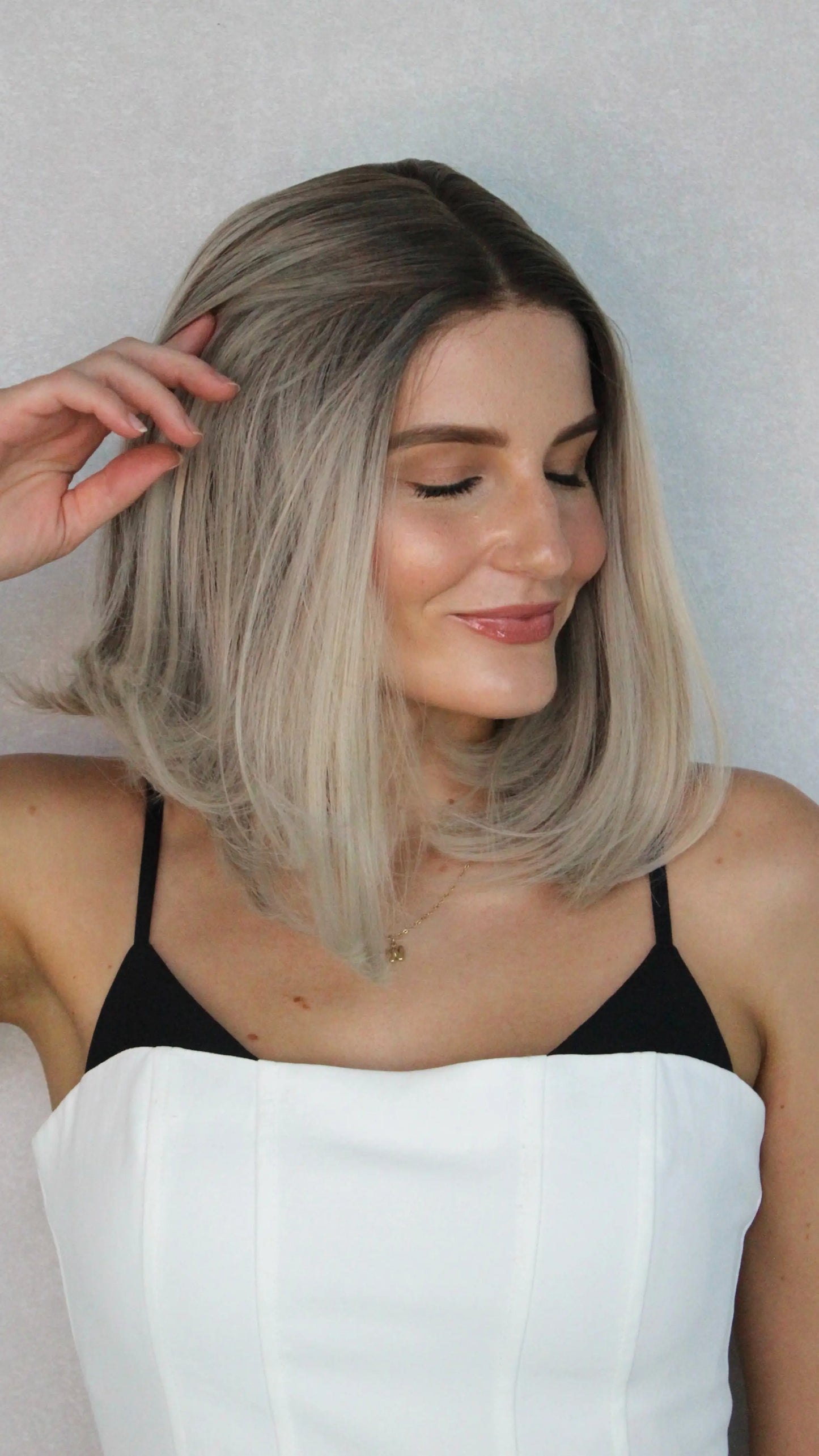 multi-toned blonde wig pulled back, showing natural hairline, dark root. heat safe.