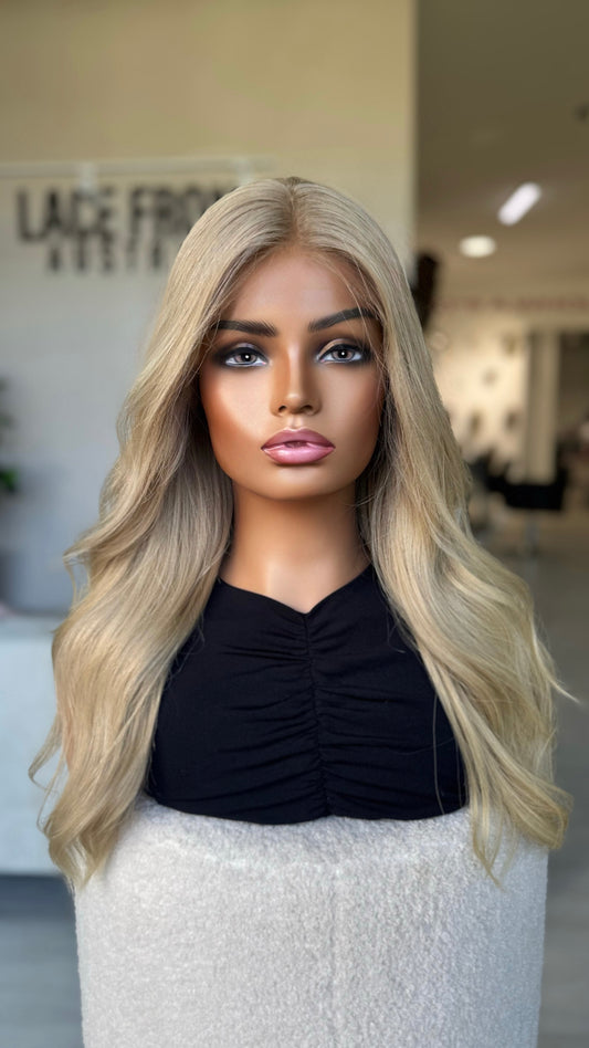 front on view of clean overall blonde hair, loose wave. lacefront, natural wig.