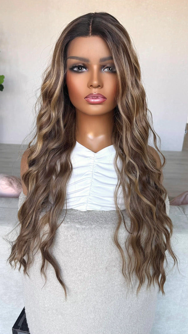 dark root to brunette with highlights wig. front of view, middle part, wavy hair.