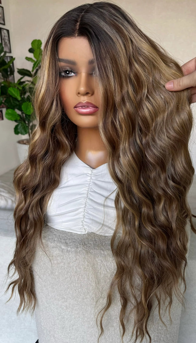 holding brunette hair with caramel light highlights, multi toned brunette synthetic. lacefront, natural wig.