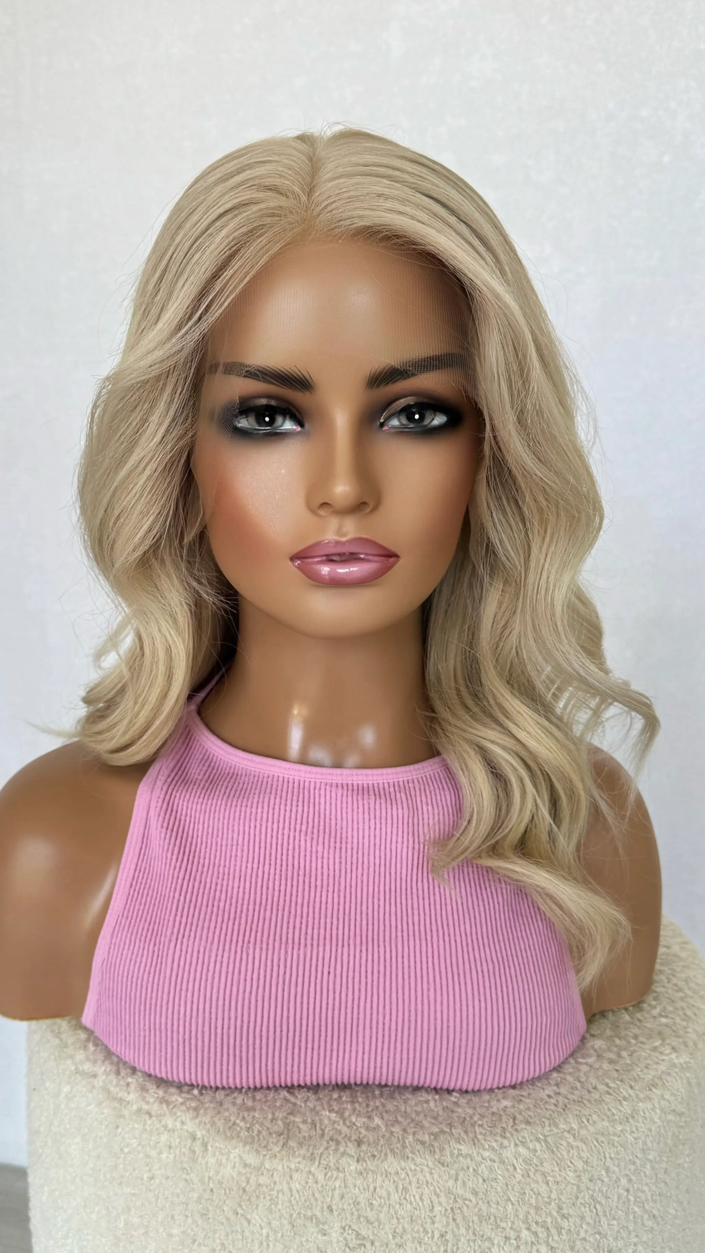 soft platinum blonde lacefront wig with golden undertones, waves in hair style. 100% Human hair wig australia.