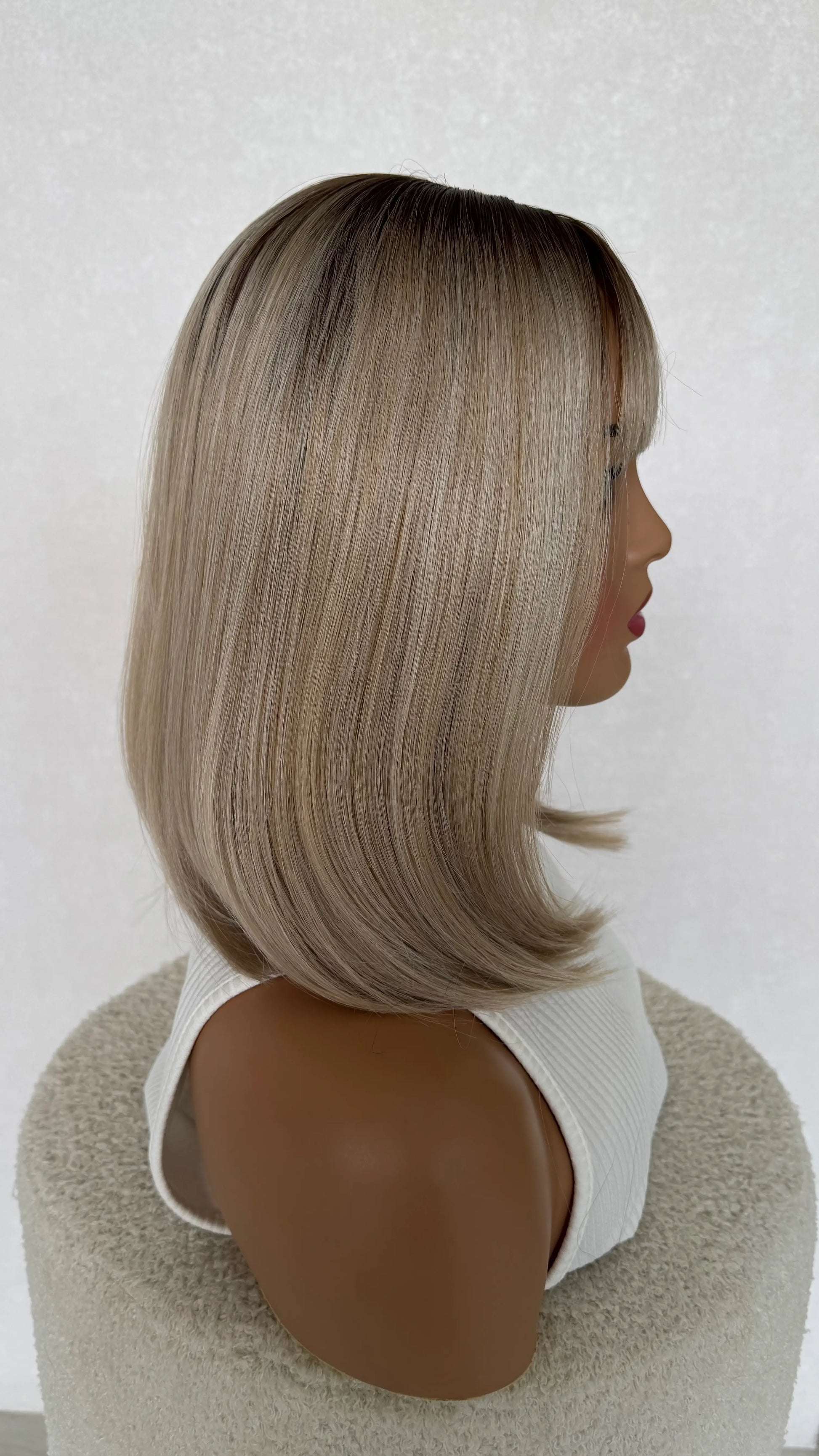 heat safe synthetic wig side view, ash beige blonde with darker root.