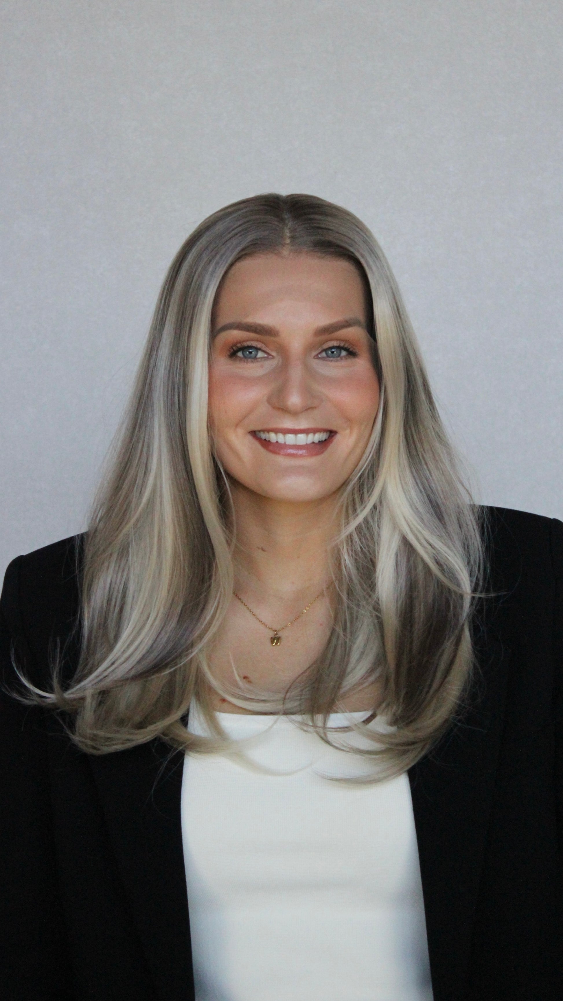 christina synthetic front on view, darker root to lowlighted blonde, layered synthetic hair, wigs australia. 