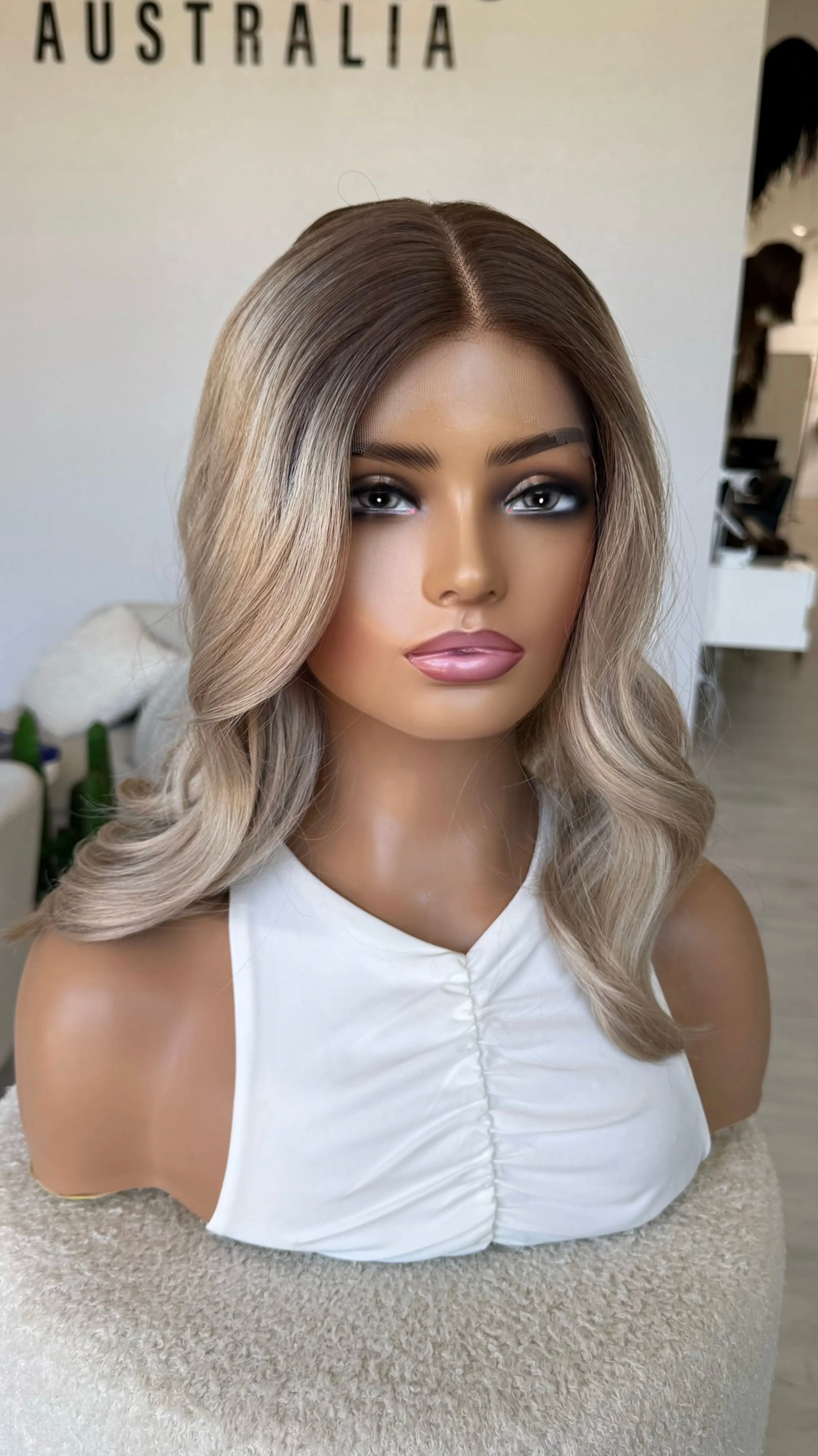 sandy beige blonde ash toned hair with dark root, wavy hair middle part, synthetic wig australia.