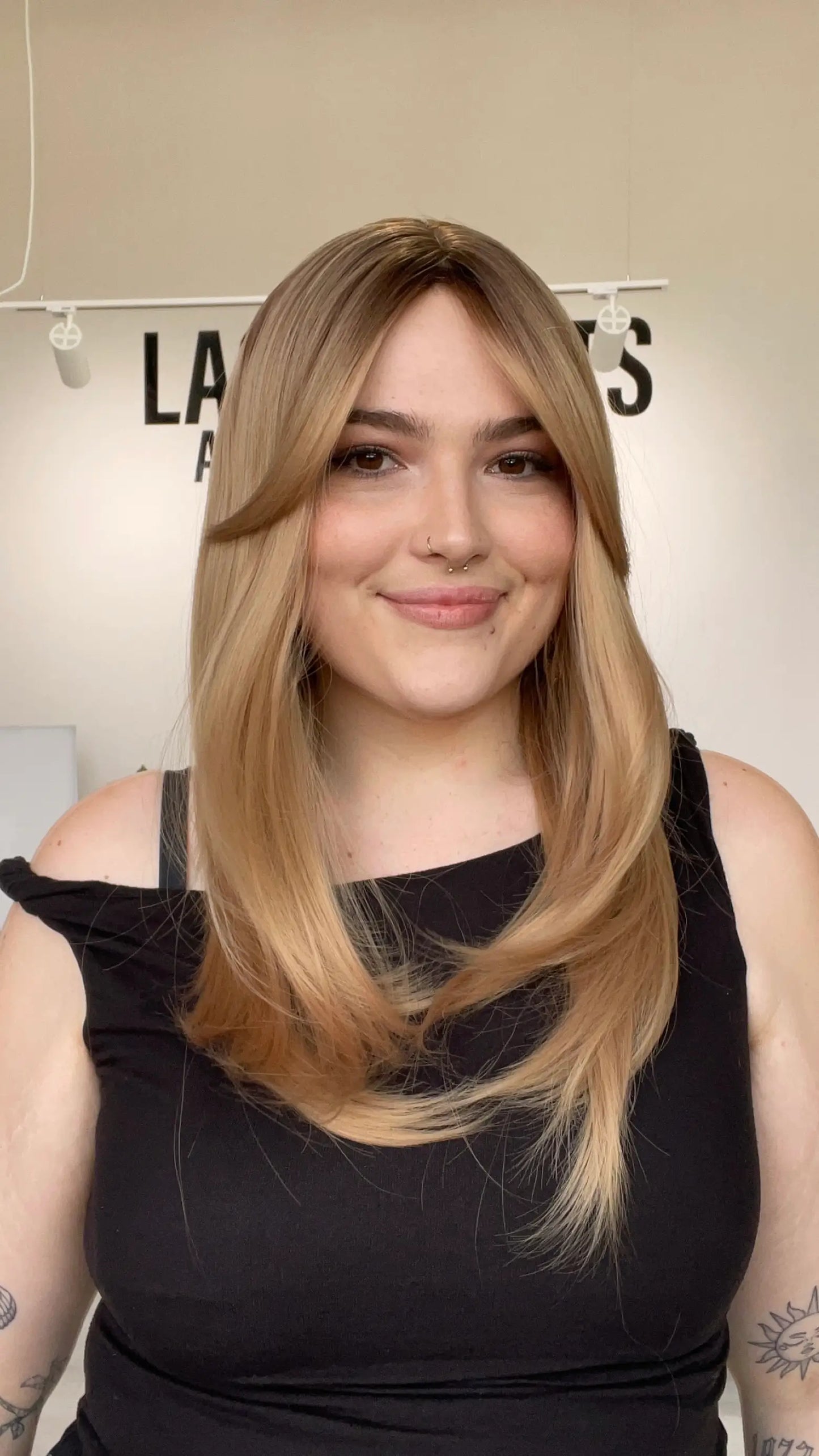 realistic layered blonde synthetic wig with curtain bangs and heat safe hair