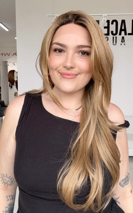 half hair back half forward, long length layered blonde hair, dark honey blonde colour with dark brunette shadow root.
