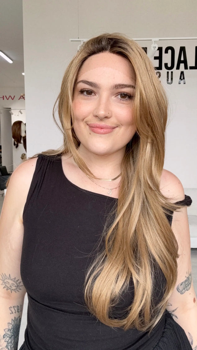 half hair back half forward, long length layered blonde hair, dark honey blonde colour with dark brunette shadow root.