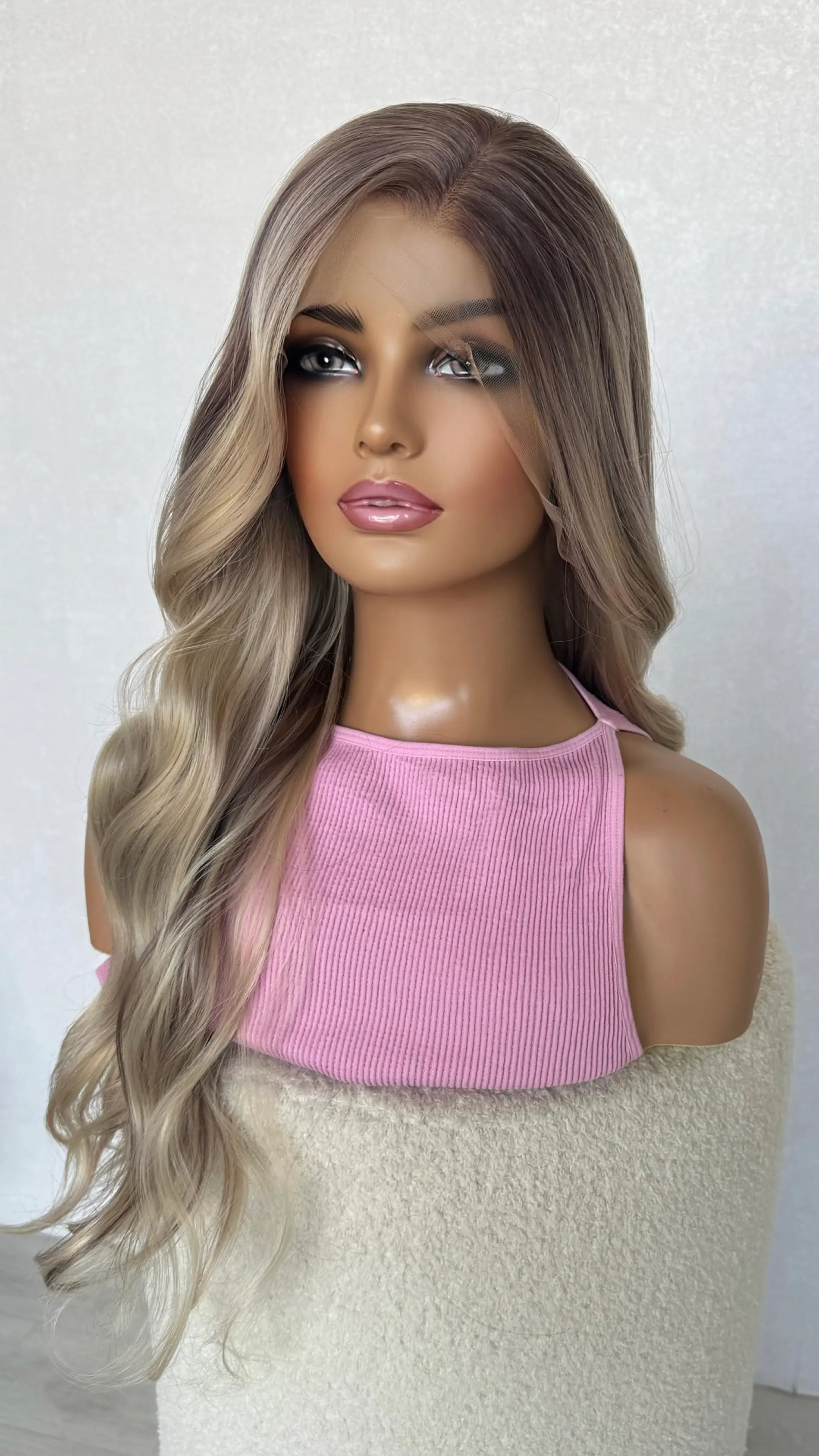 darker root to ash blonde hair, half hair back.