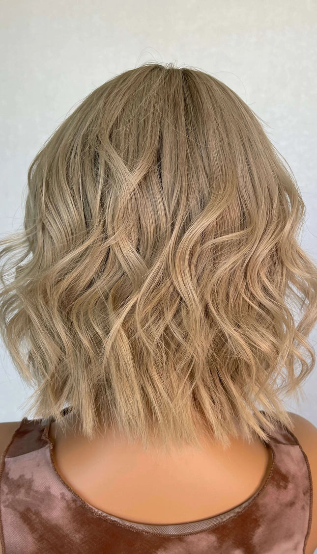 Lace front medical grade glueless wig with blonde wavy hair. 