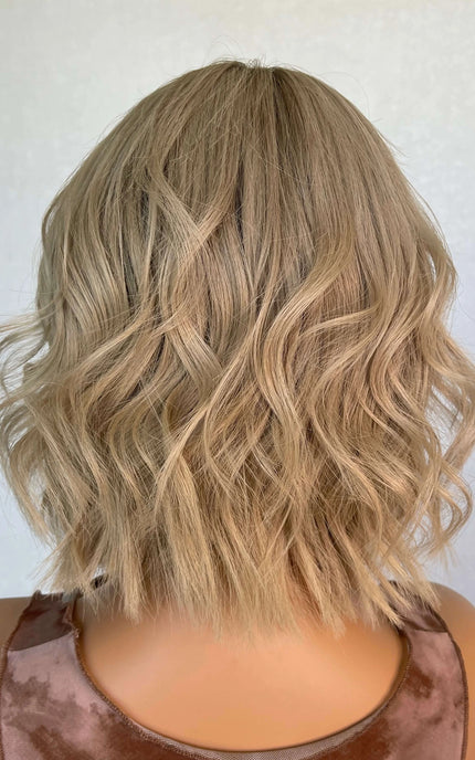 Lace front medical grade glueless wig with blonde wavy hair. 