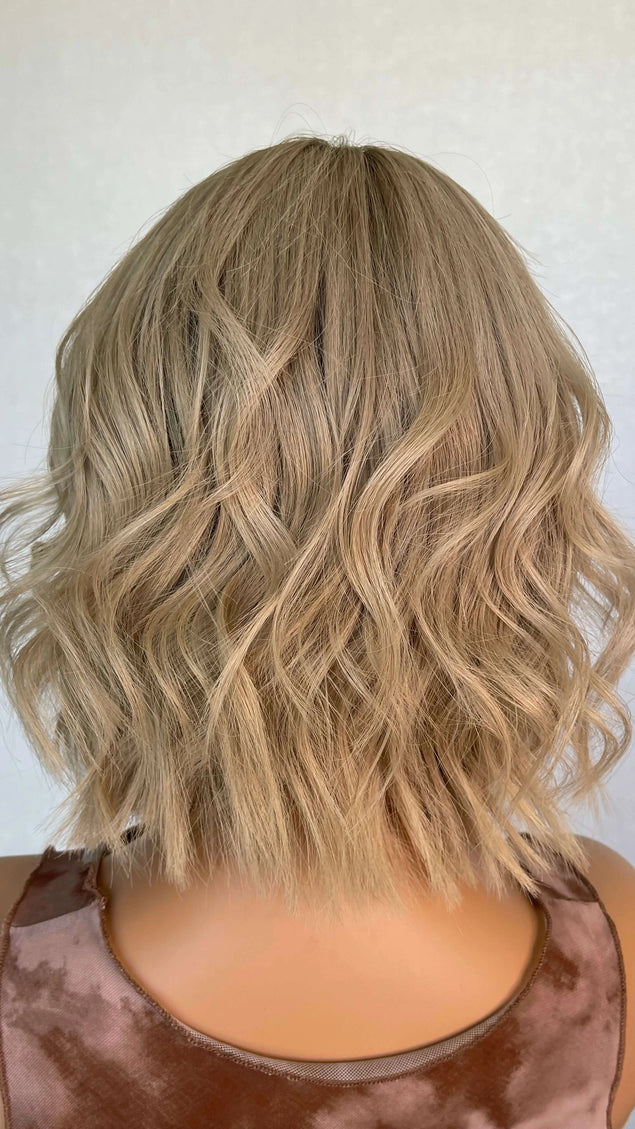 Lace front medical grade glueless wig with blonde wavy hair. 