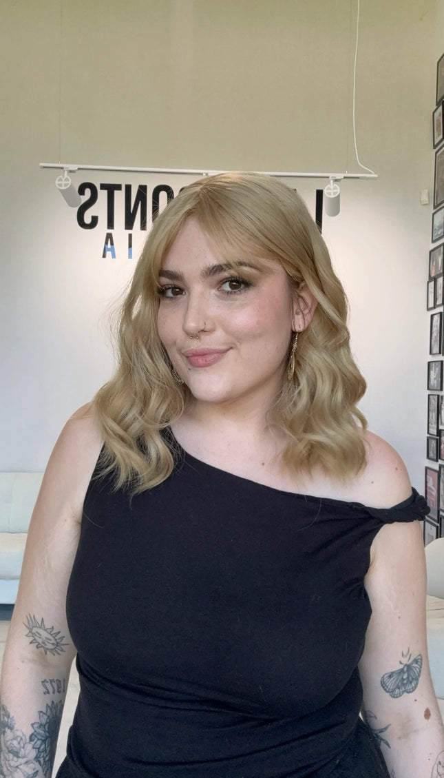 honey blonde wavy hair topper with fringe, middle parting.
