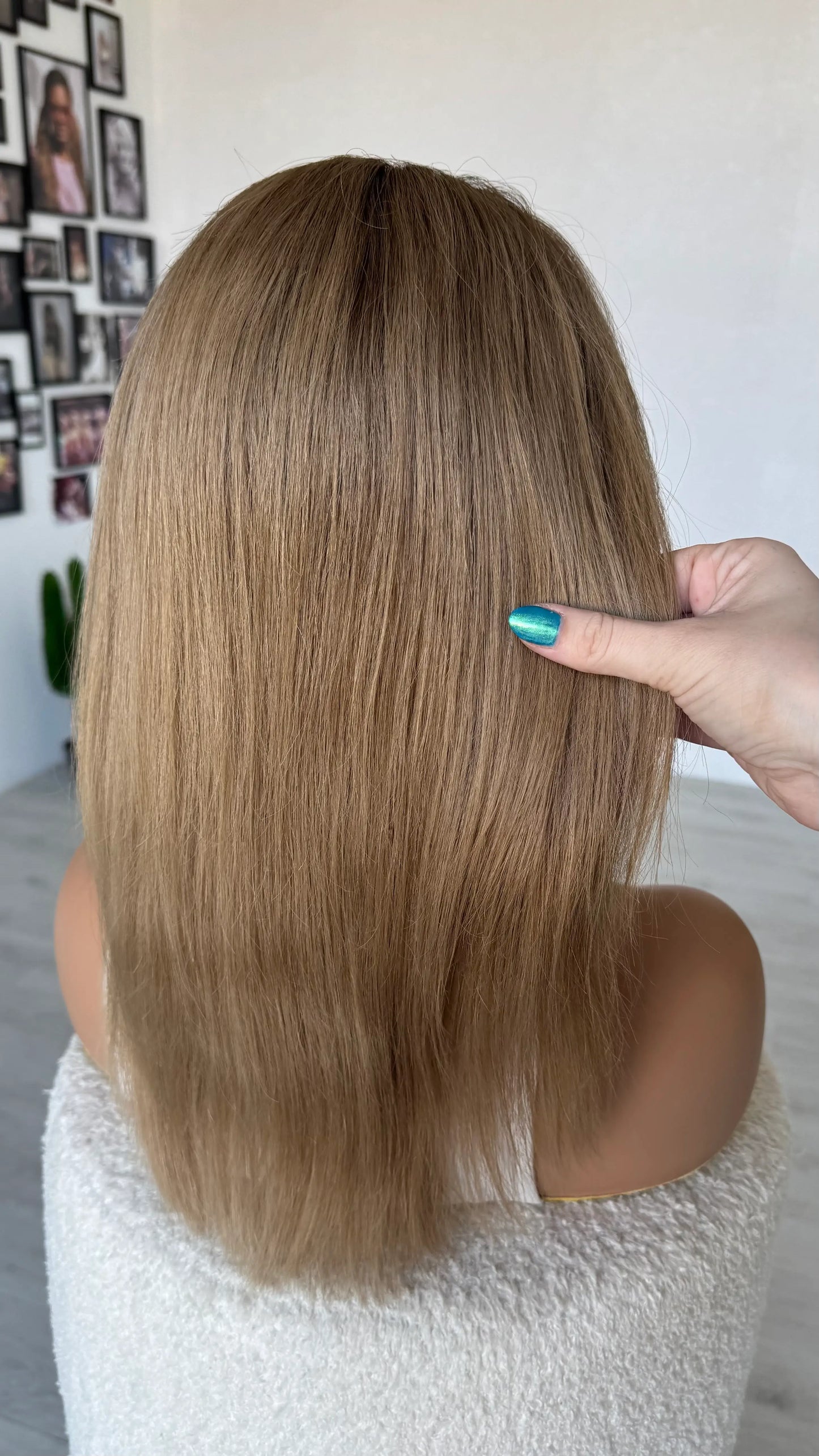 back view holding long blonde hair 18 inches ready to send australia wigs. 