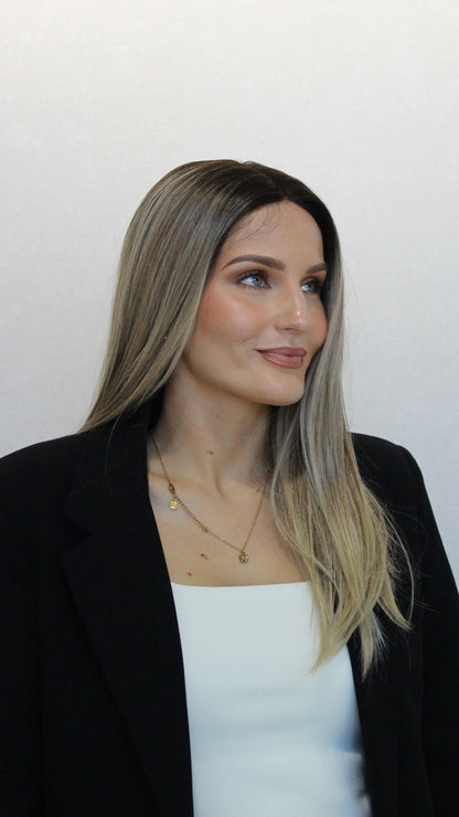 side on view, darker root to ombre blonde cool toned hair. heat safe synthetics.