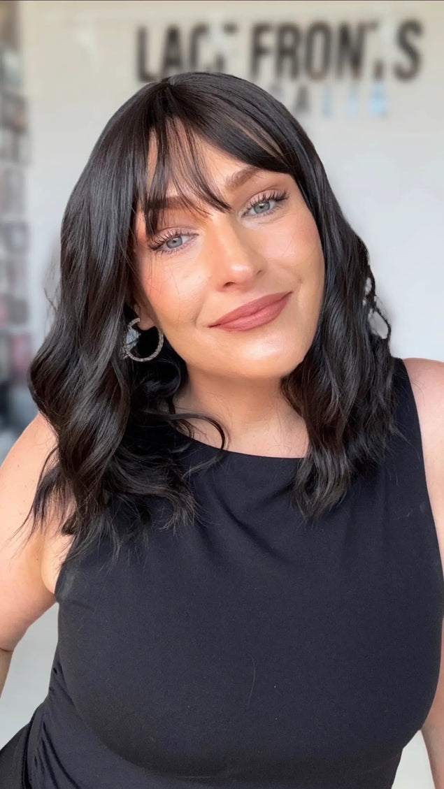 jett black wavy hair wig with middle part and collarbone length hair, wispy long fringe.