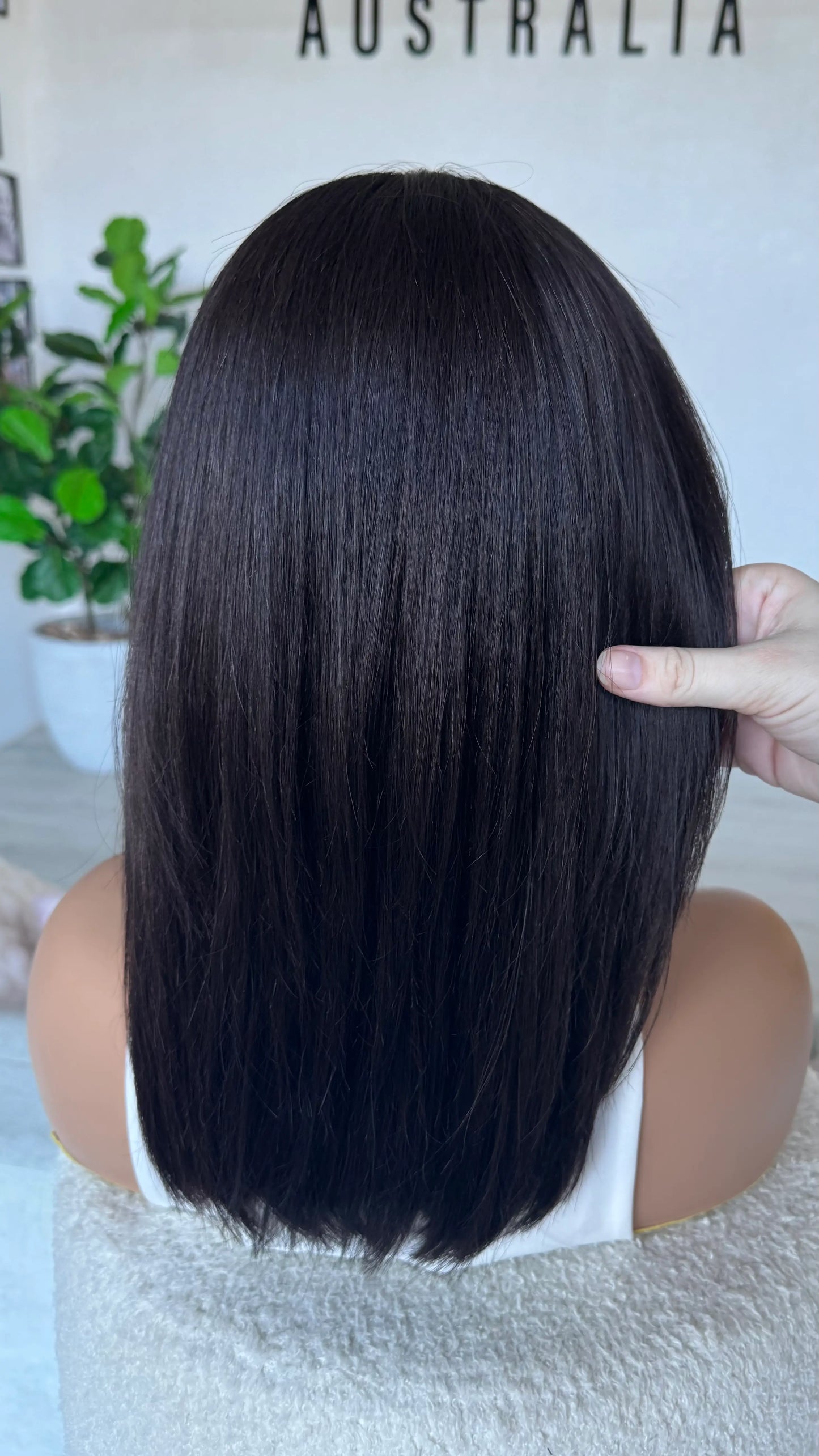 back view holding dark brown hair wig. 16 inch length, silky natural hair lacefront wig australia.