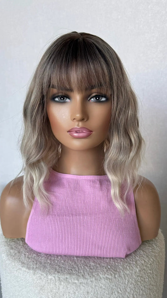 ash blonde wavy fringe wig with dark root and light end.