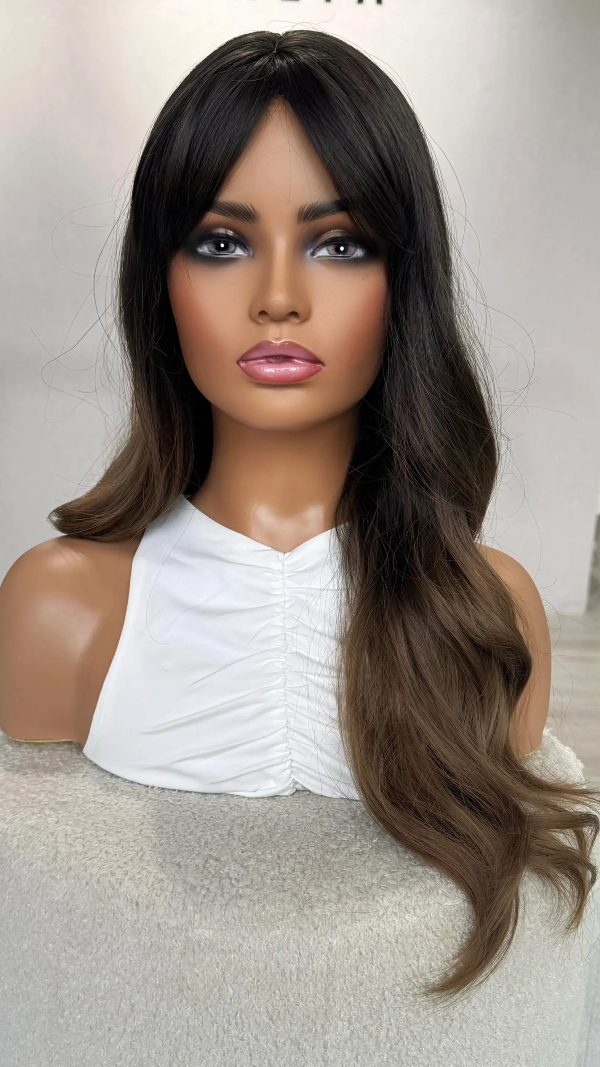 front view of hair, half hair is back, half forward, ombre brunette hair. heat safe synthetic.