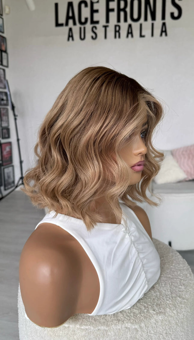 natural blonde ombre wig with wavy styling, middle part with face framing highlight, blonde human hair wigs australia.