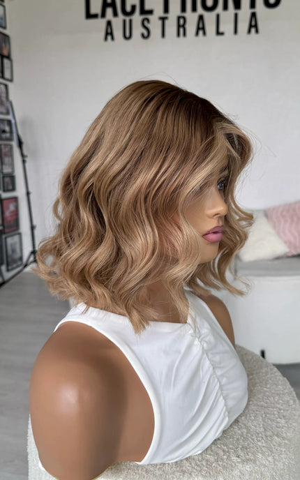 natural blonde ombre wig with wavy styling, middle part with face framing highlight, blonde human hair wigs australia.