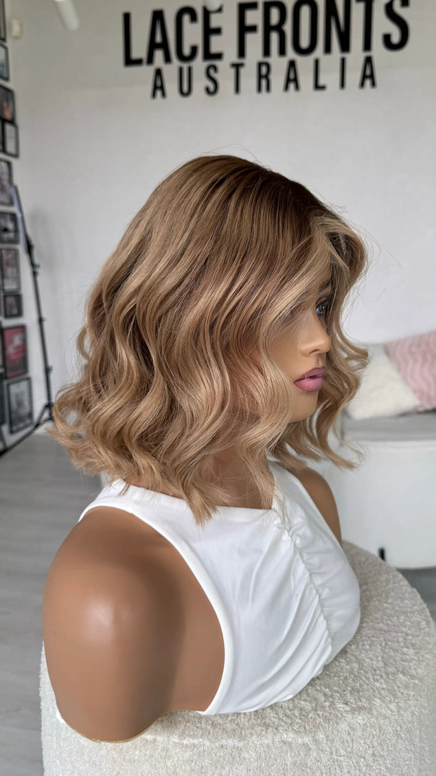 natural blonde ombre wig with wavy styling, middle part with face framing highlight, blonde human hair wigs australia.