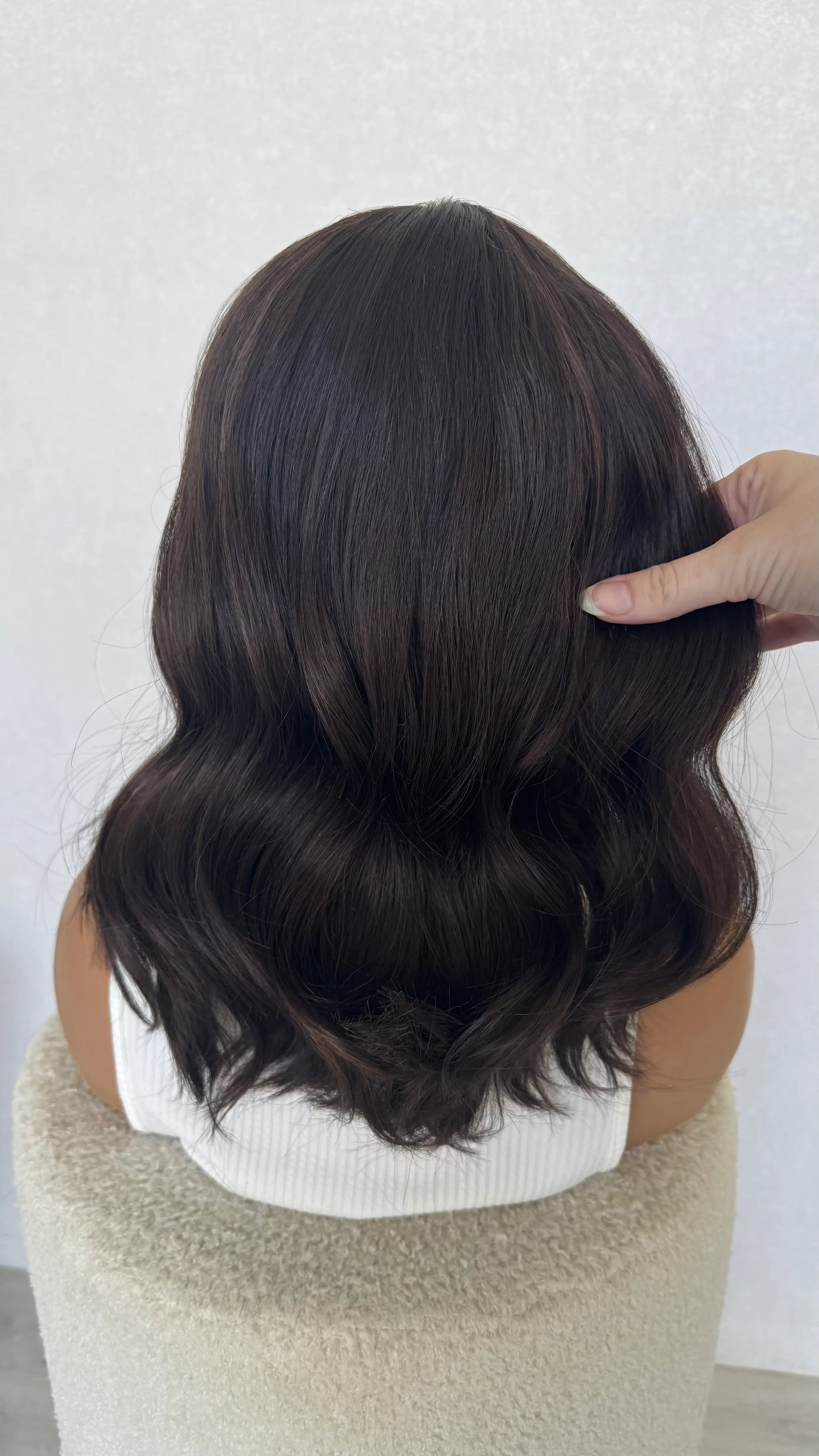 lace front brunette wig from behind, holding the hair.