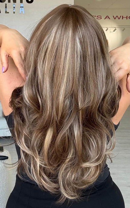 Medium length 20–22 inch warm brunette hair with ash and honey blonde highlights, cut in soft layers.