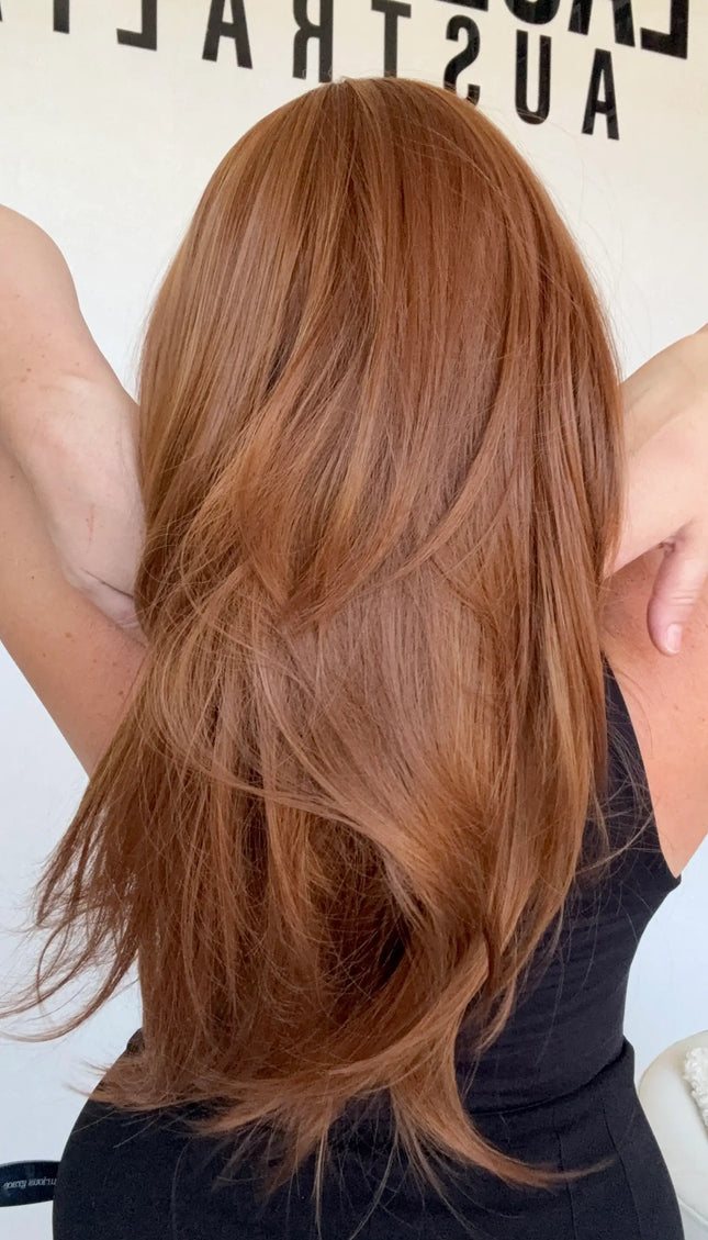 layered copper hair synthetic wig, middle part with curtain bangs.