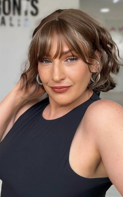 a soft wavy light brunette short bob with a soft fringe and middle part, blonde highlights througout.