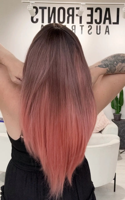 a long length pink ombre coloured glueless synthetic wig with heat safe hair.