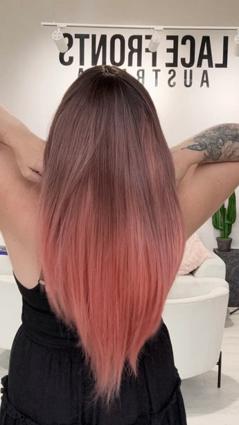 a long length pink ombre coloured glueless synthetic wig with heat safe hair.